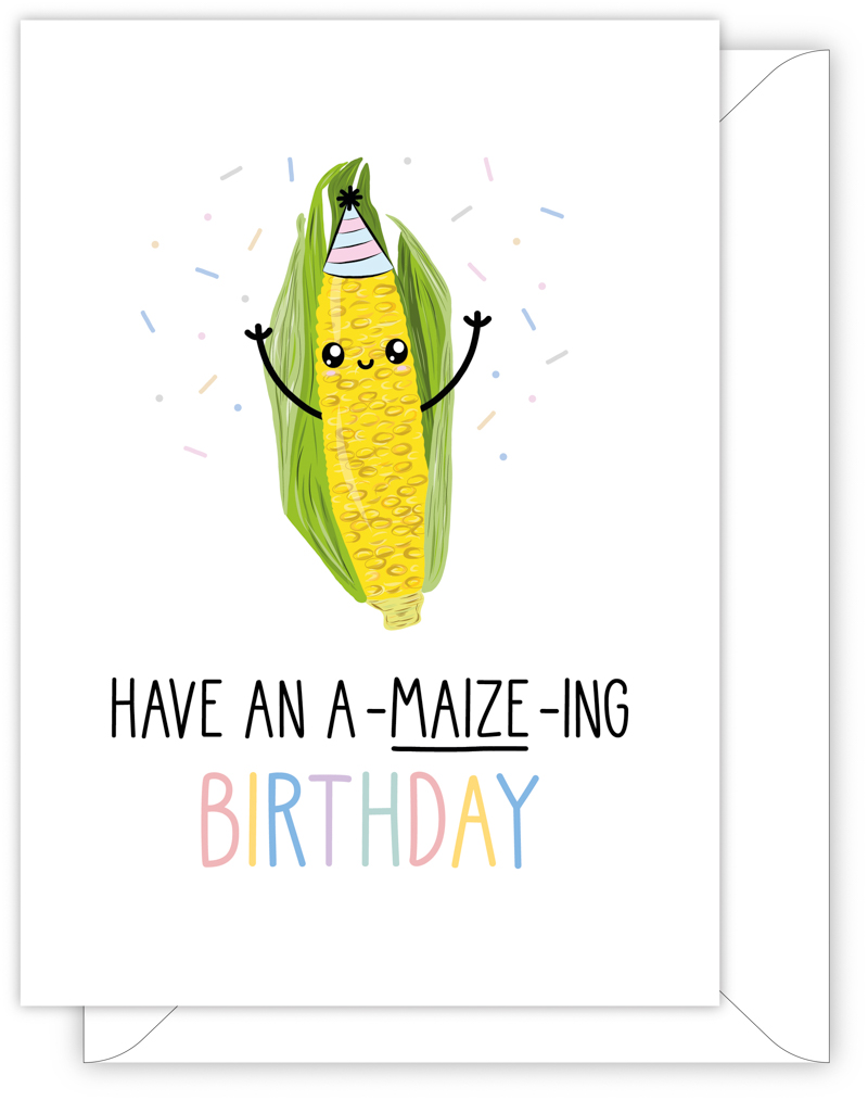 A funny birthday card with a hand drawn image of a corn on the cob, or maize, wearing a party hat with blue and pink stripes. It is throwing confetti. The card caption is: Have An A-Maize-Ing Birthday